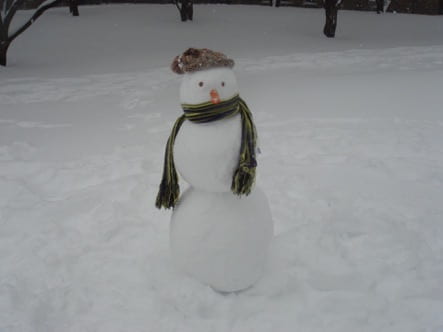 A snowman wearing a scarf and hat.